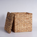 Set of four woven water hyacinth storage baskets in graduated sizes