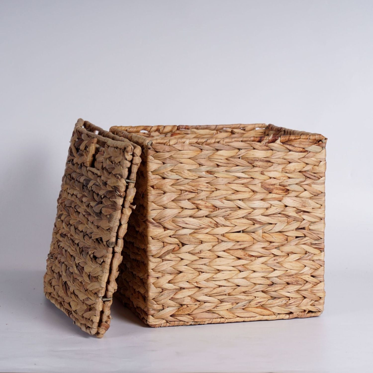 Set of four woven water hyacinth storage baskets in graduated sizes