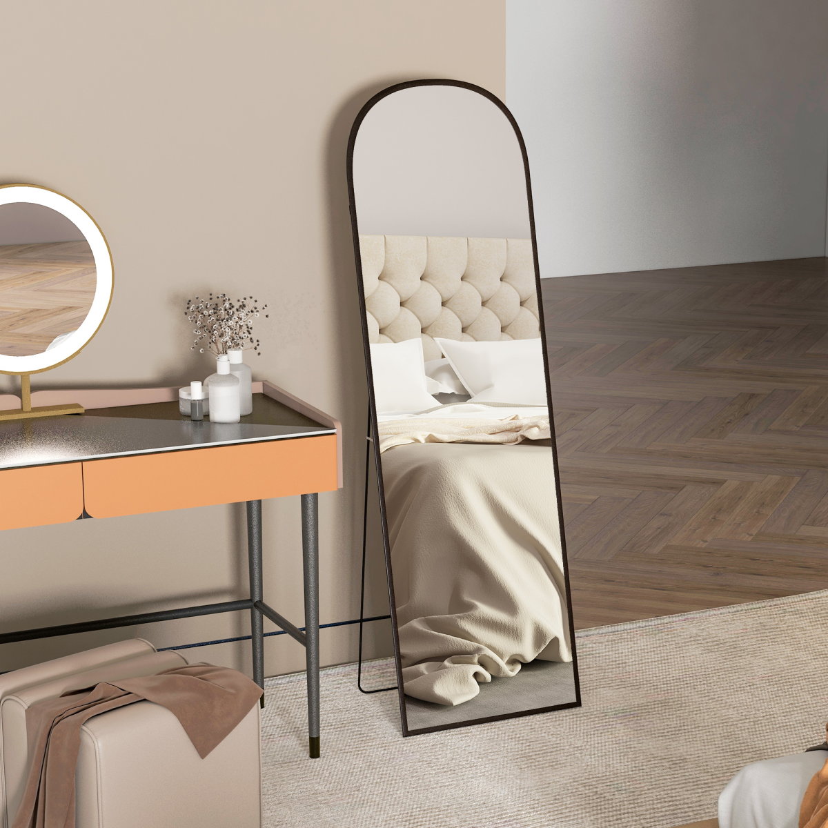 Black arched dressing mirror beside a modern vanity table