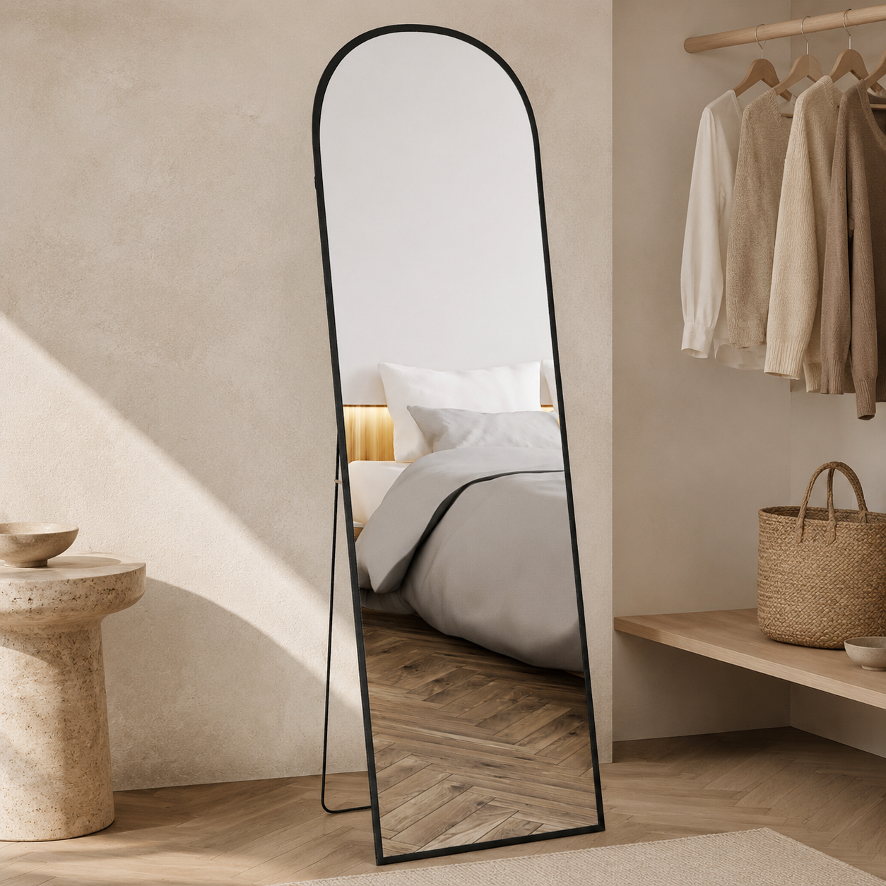 Black arched full-length mirror in a warm dressing room