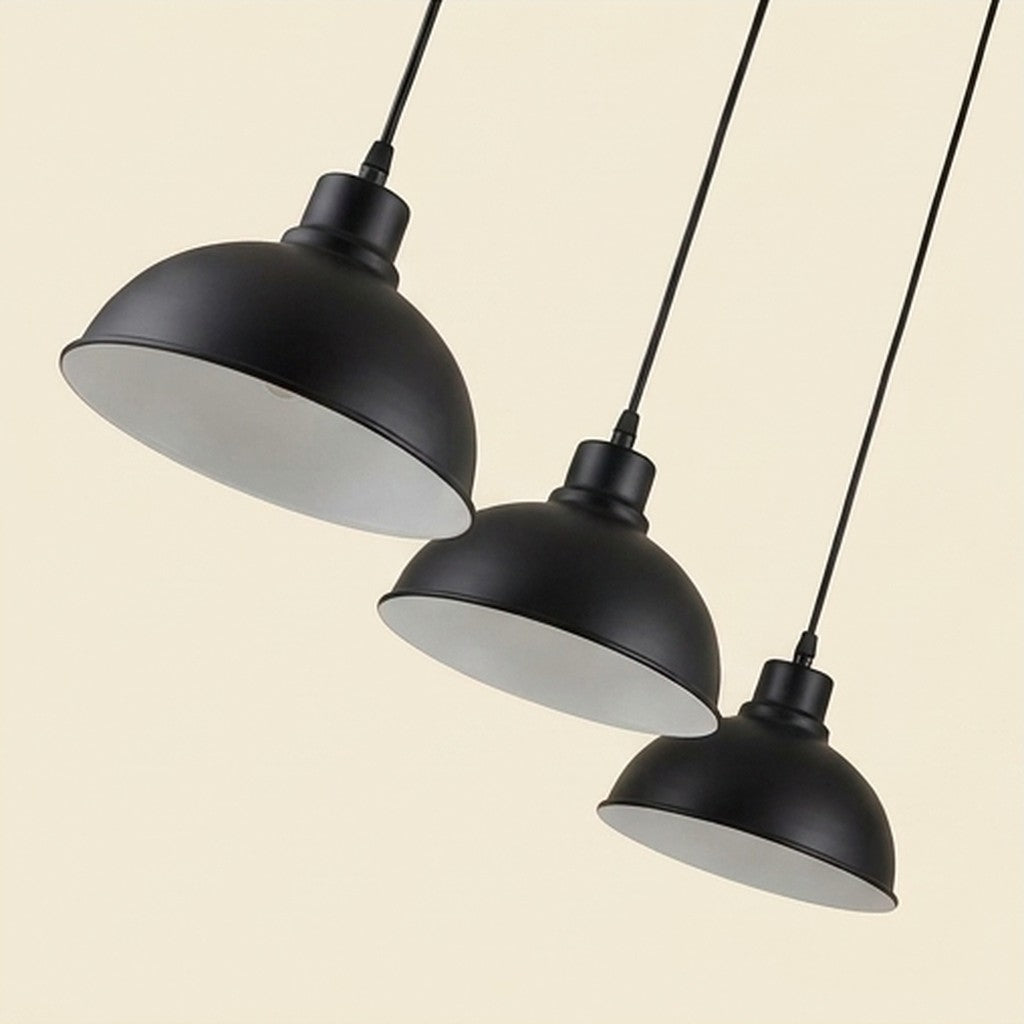 Angled view of industrial pendant lights with black dome shades