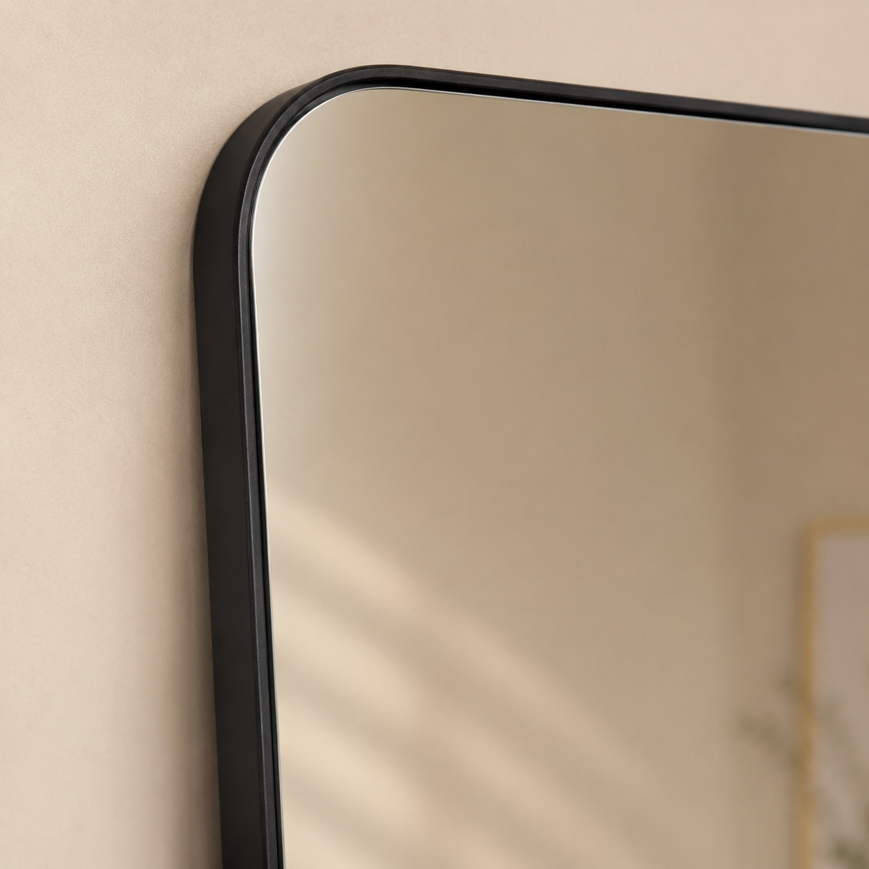 Close-up of the slim black frame and rounded mirror corner