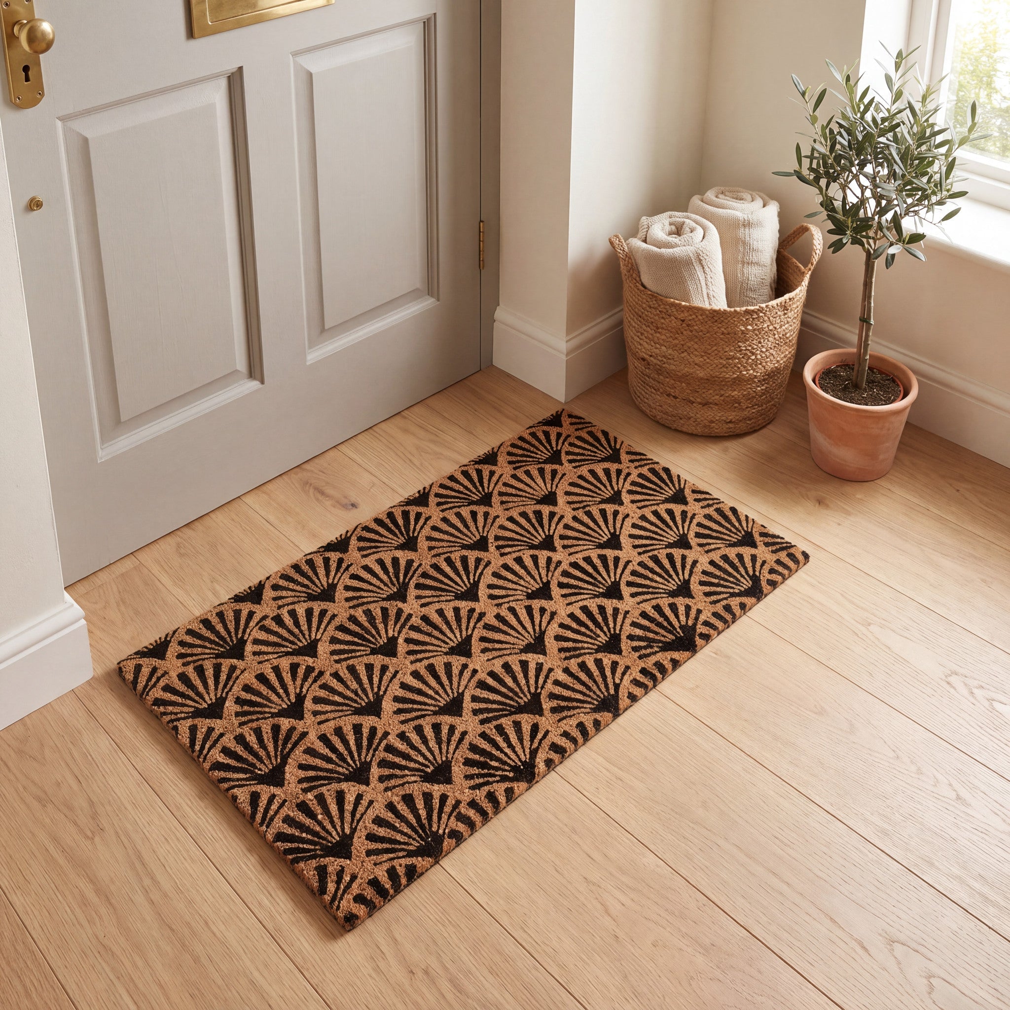 Black scallop coir entrance mat styled by a neutral front door and woven basket