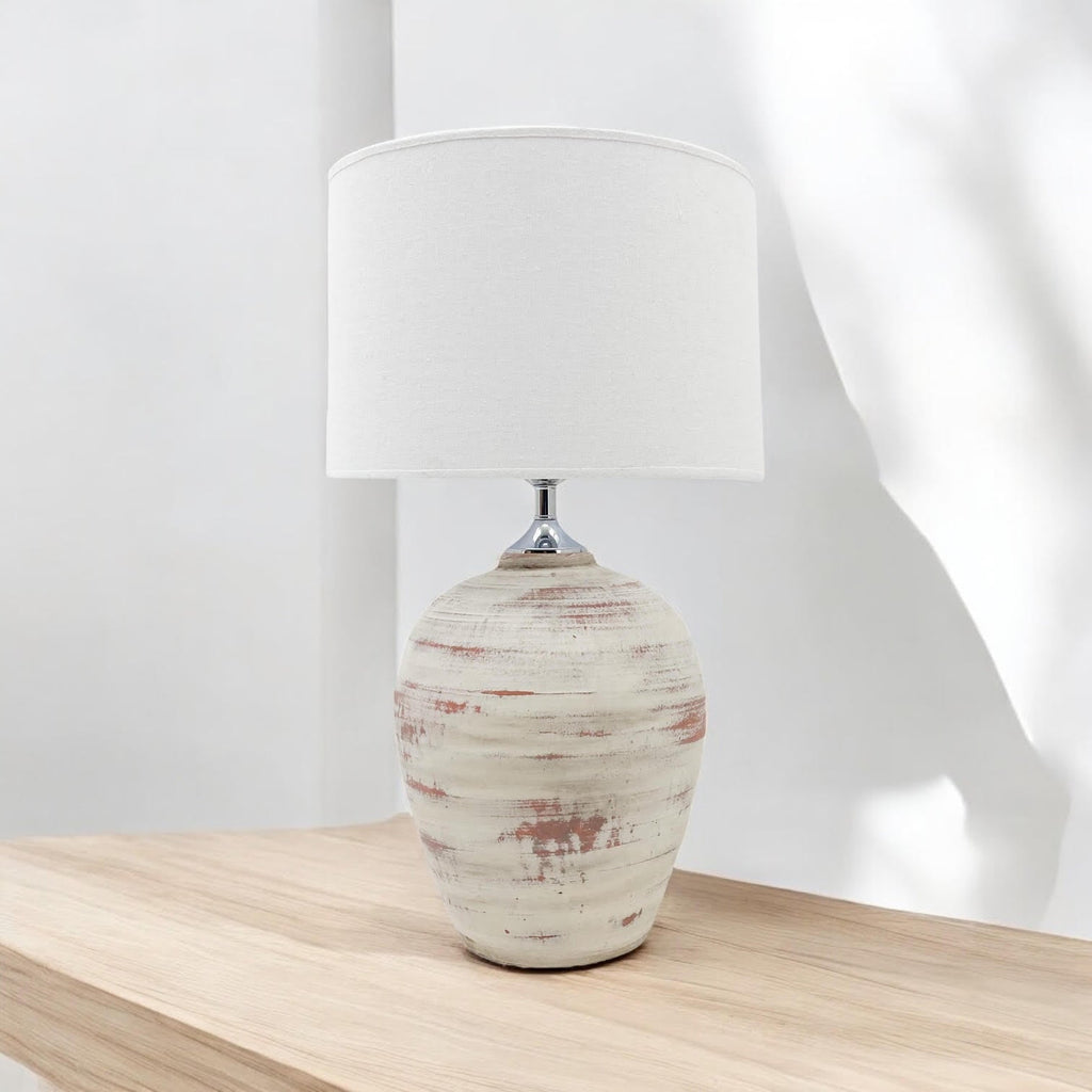 Rustic cream ceramic table lamp photographed in natural light