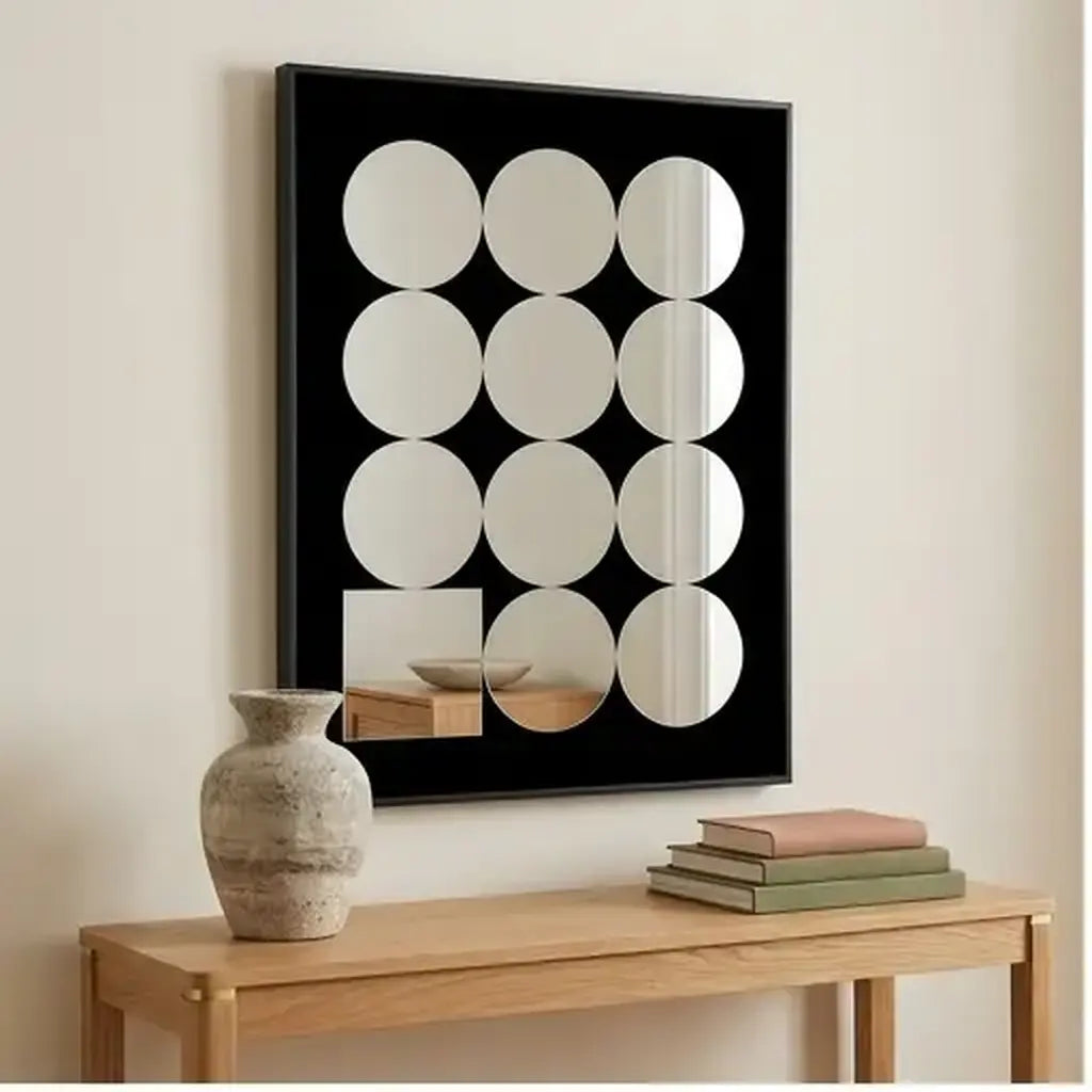 Decorative acrylic mirror wall art with black frame in a contemporary living room