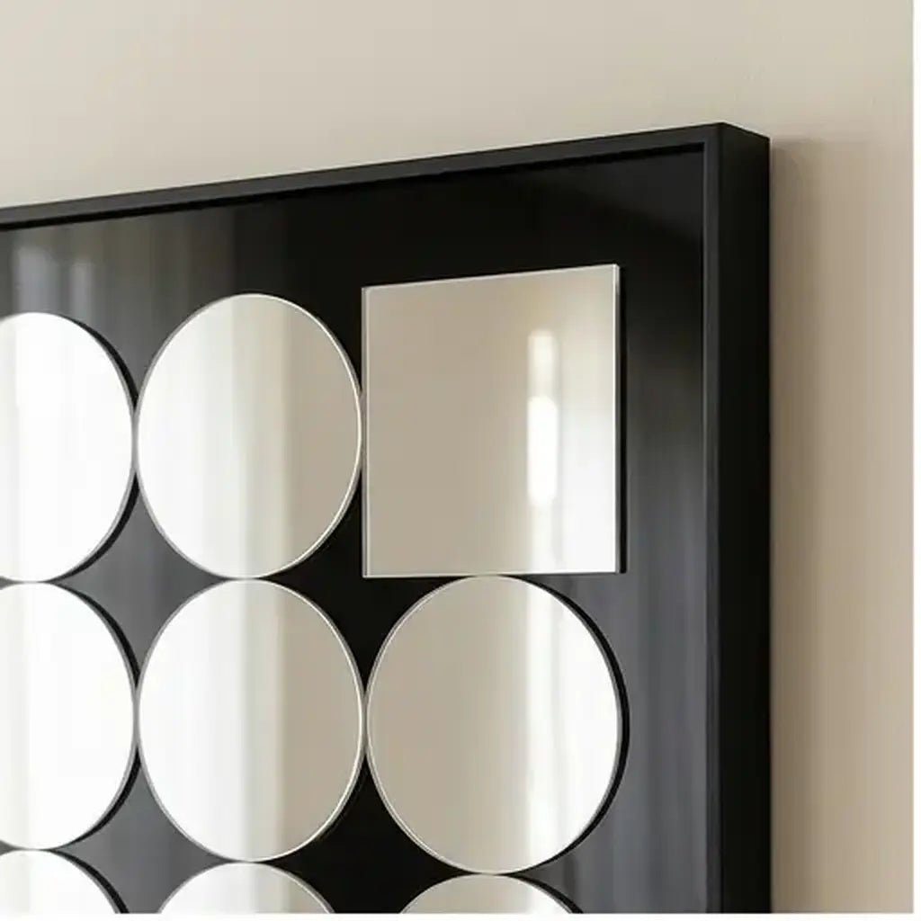 Decorative acrylic mirror wall art with black frame in soft natural daylight in a living room