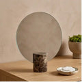 Freestanding vanity mirror with marble-effect base in a contemporary bedroom