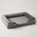 Grey pet sofa bed with plush washable cover on a white background