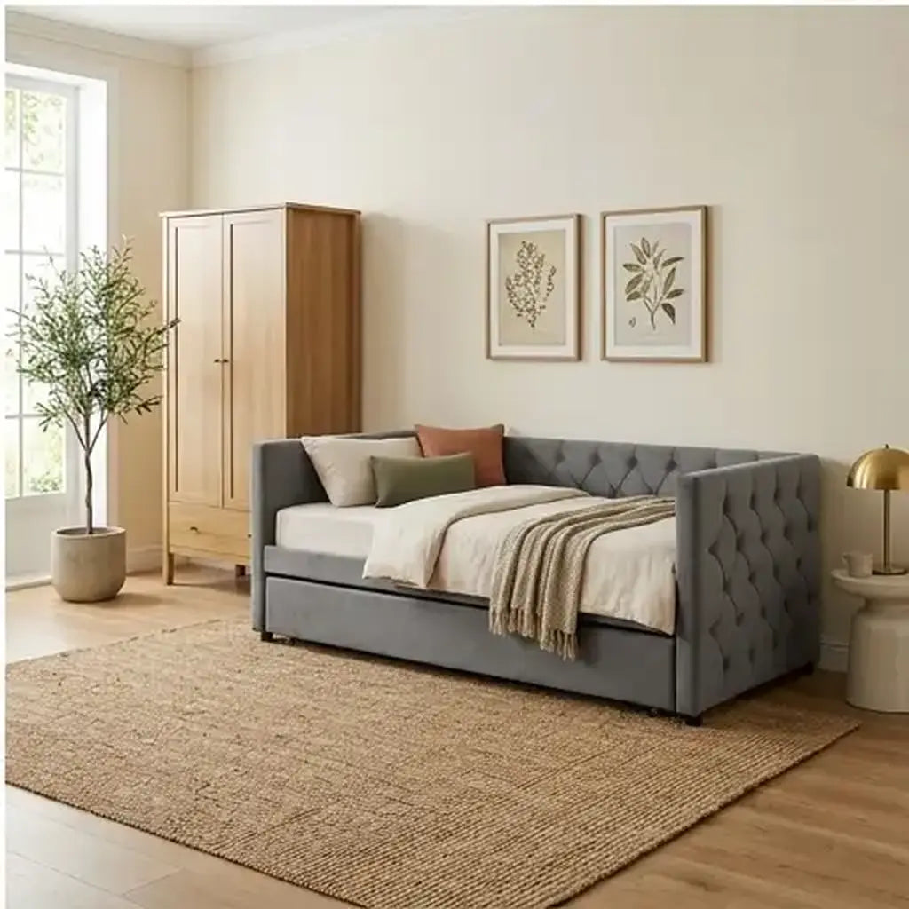 Grey velvet daybed with trundle and charging point with warm natural wood styling in a guest room