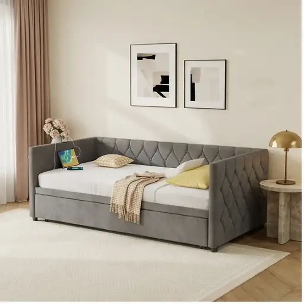 Grey velvet daybed with trundle and charging point in soft natural daylight in a guest room