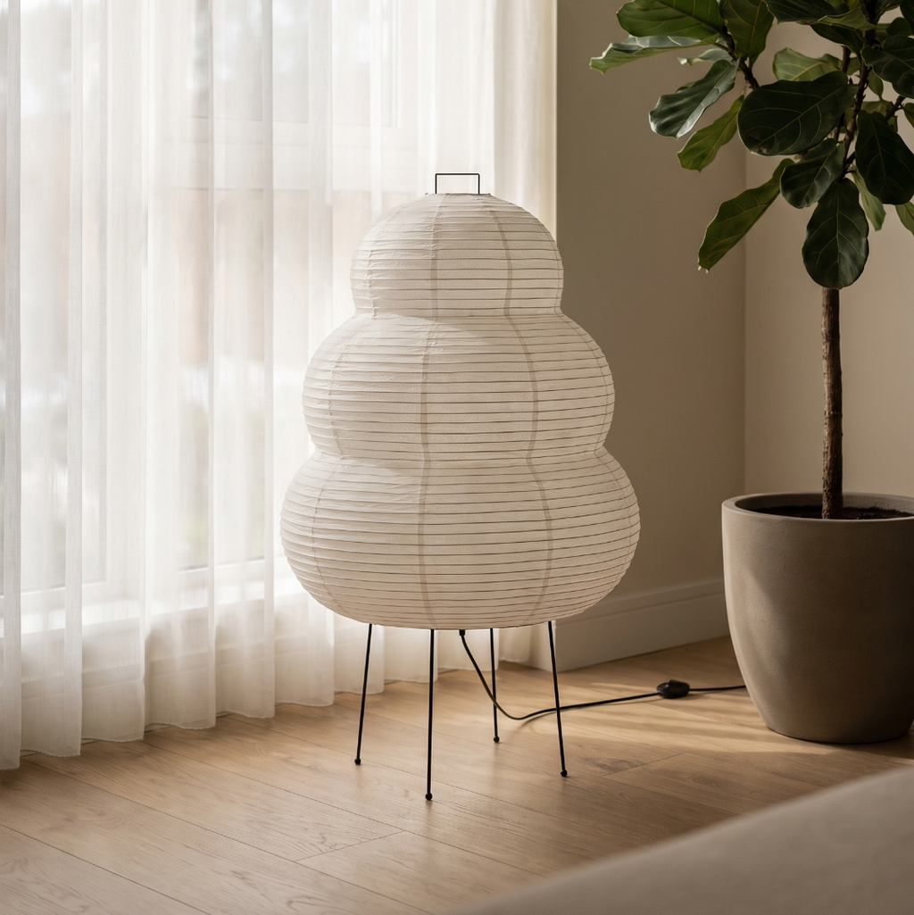 Rice paper floor lamp by a window with sheer curtains