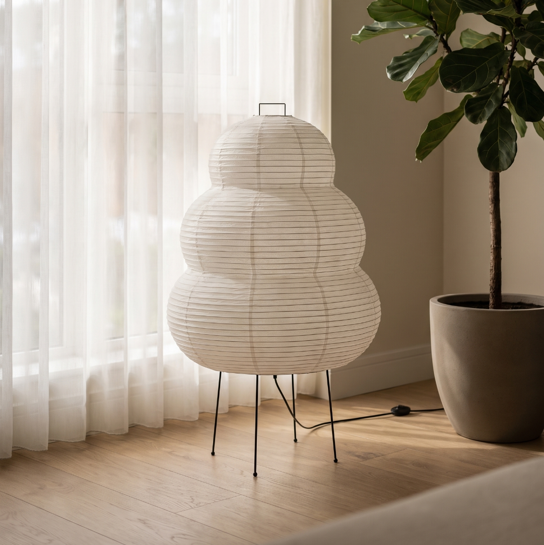 Rice paper floor lamp by a window with sheer curtains