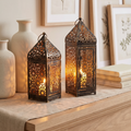 Lantern candle holder on a mantel with soft decor