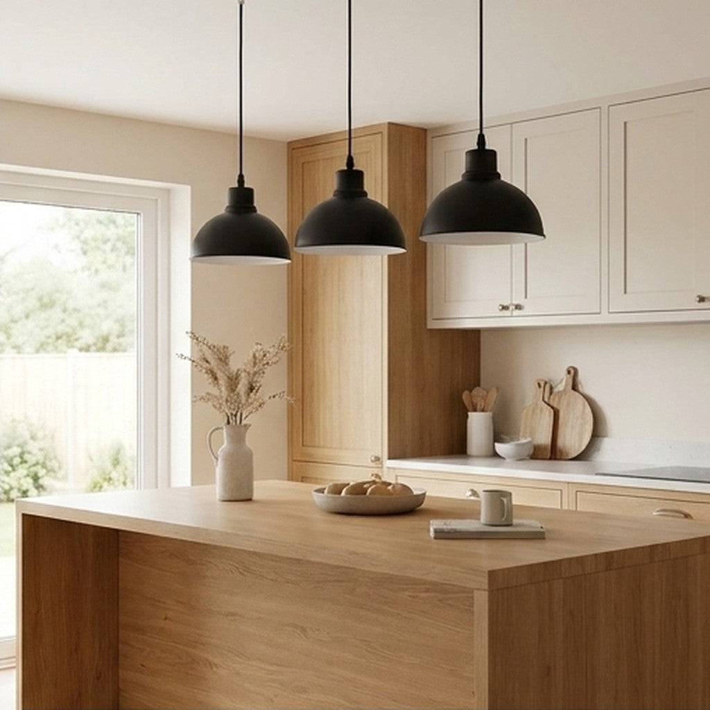 Black 3-light pendant hanging above a wooden kitchen island