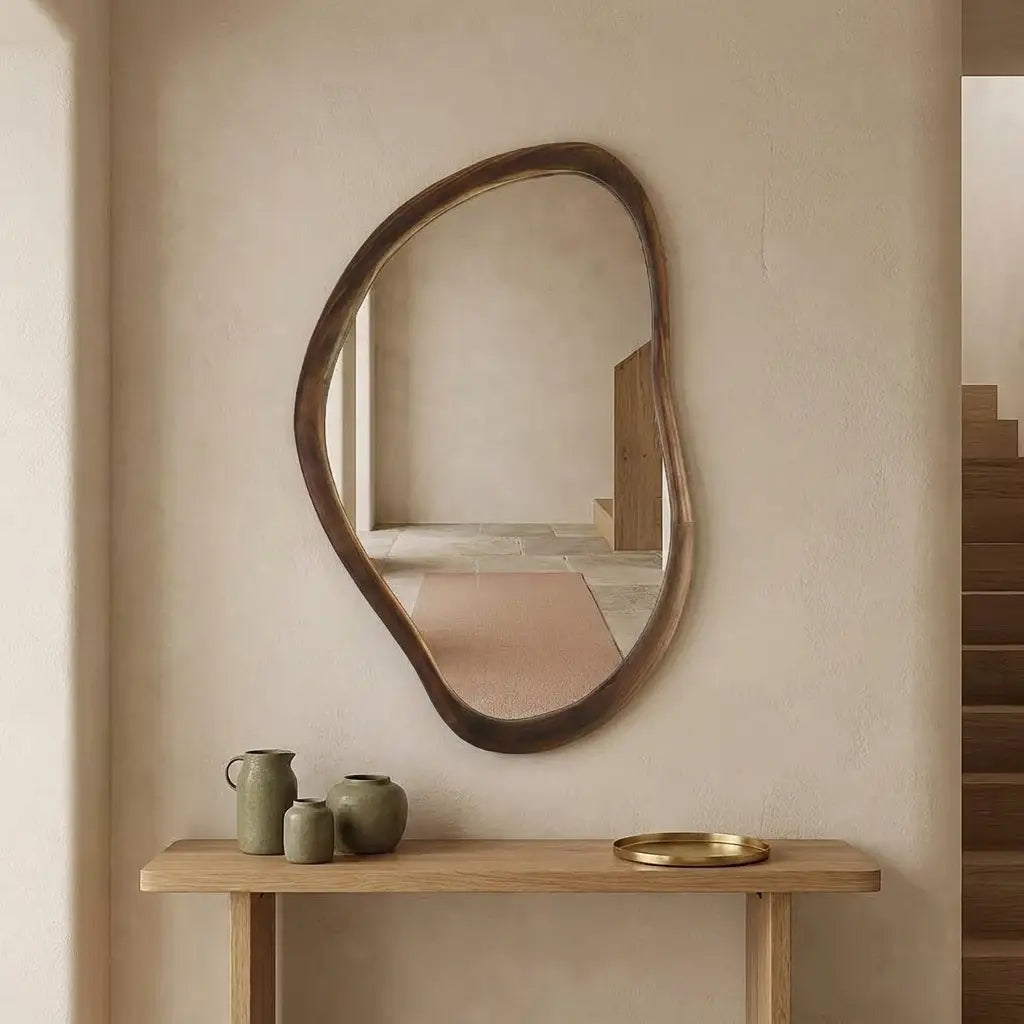 Irregular walnut wall mirror measuring 50 by 70cm in a contemporary hallway