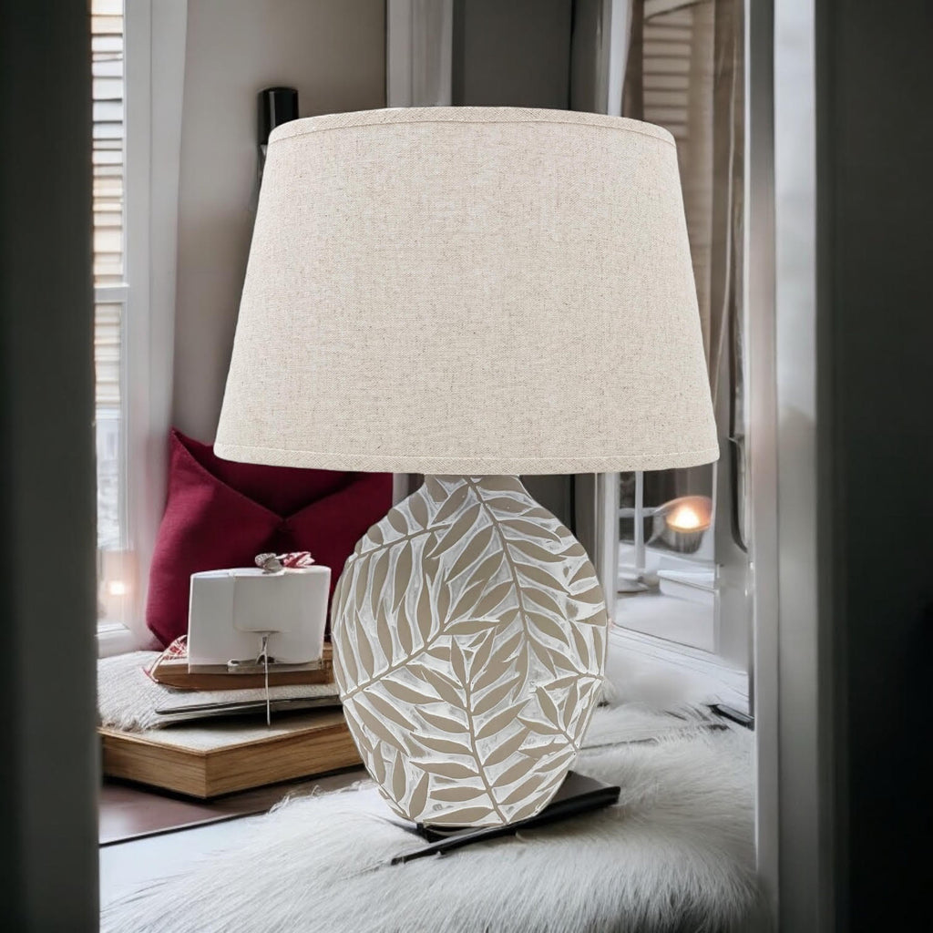 Leaf-pattern ceramic table lamp styled by a window seat
