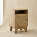 Narrow rattan bedside table with cane door