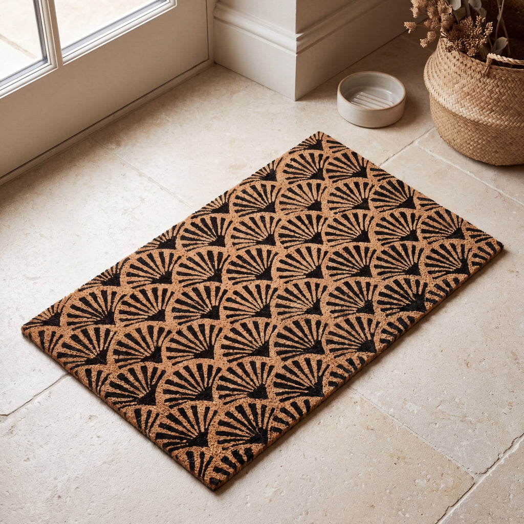 Natural coir doormat with bold black scallop pattern shown from above