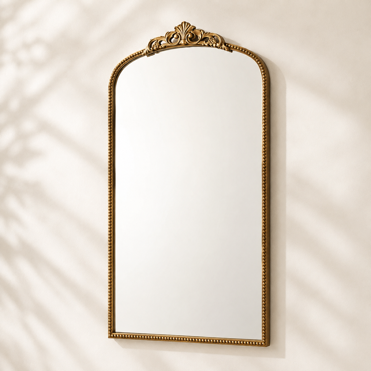 Distressed gold ornate arch wall mirror with carved crest and beaded frame