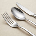 Close-up of polished stainless steel fork spoon and table knife