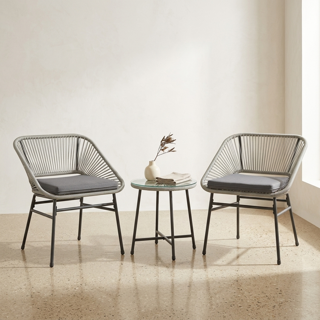 Light grey rattan bistro set with two chairs and table on a white background