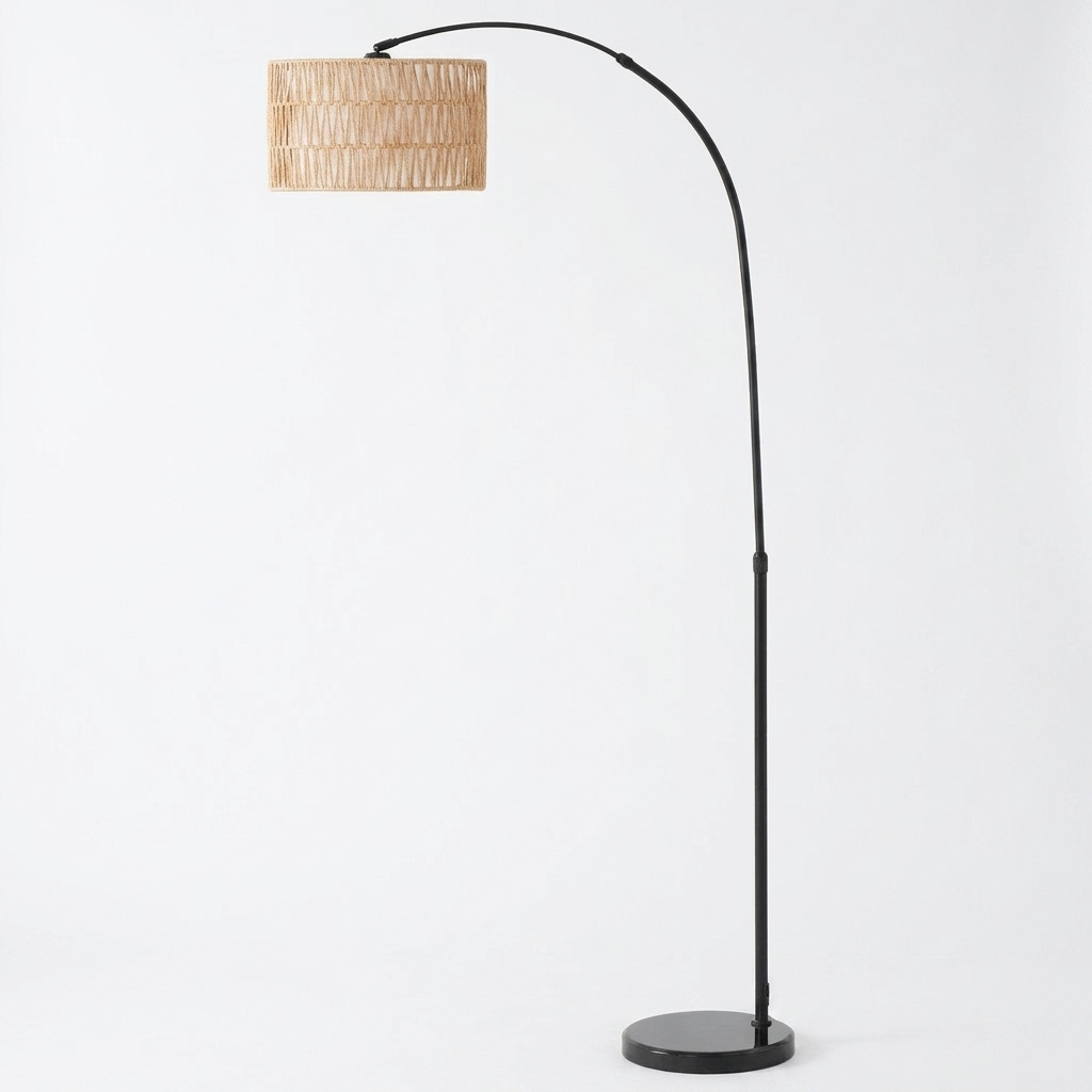 Rattan arc floor lamp with hemp rope shade on a white background