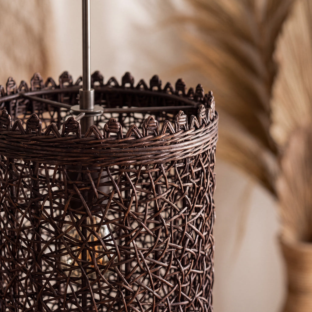 Close-up of the natural woven shade on a dark rattan pendant light