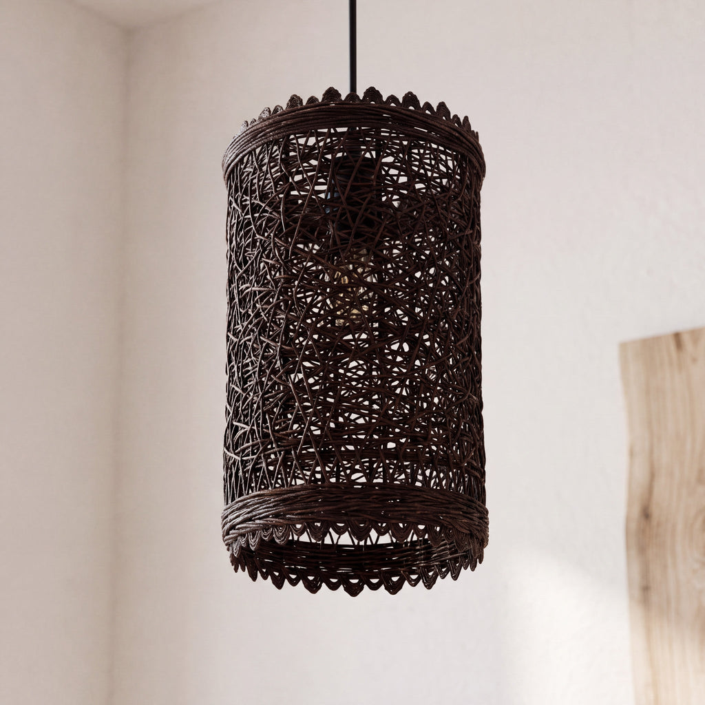 Rattan pendant light with natural woven shade hanging against a neutral wall