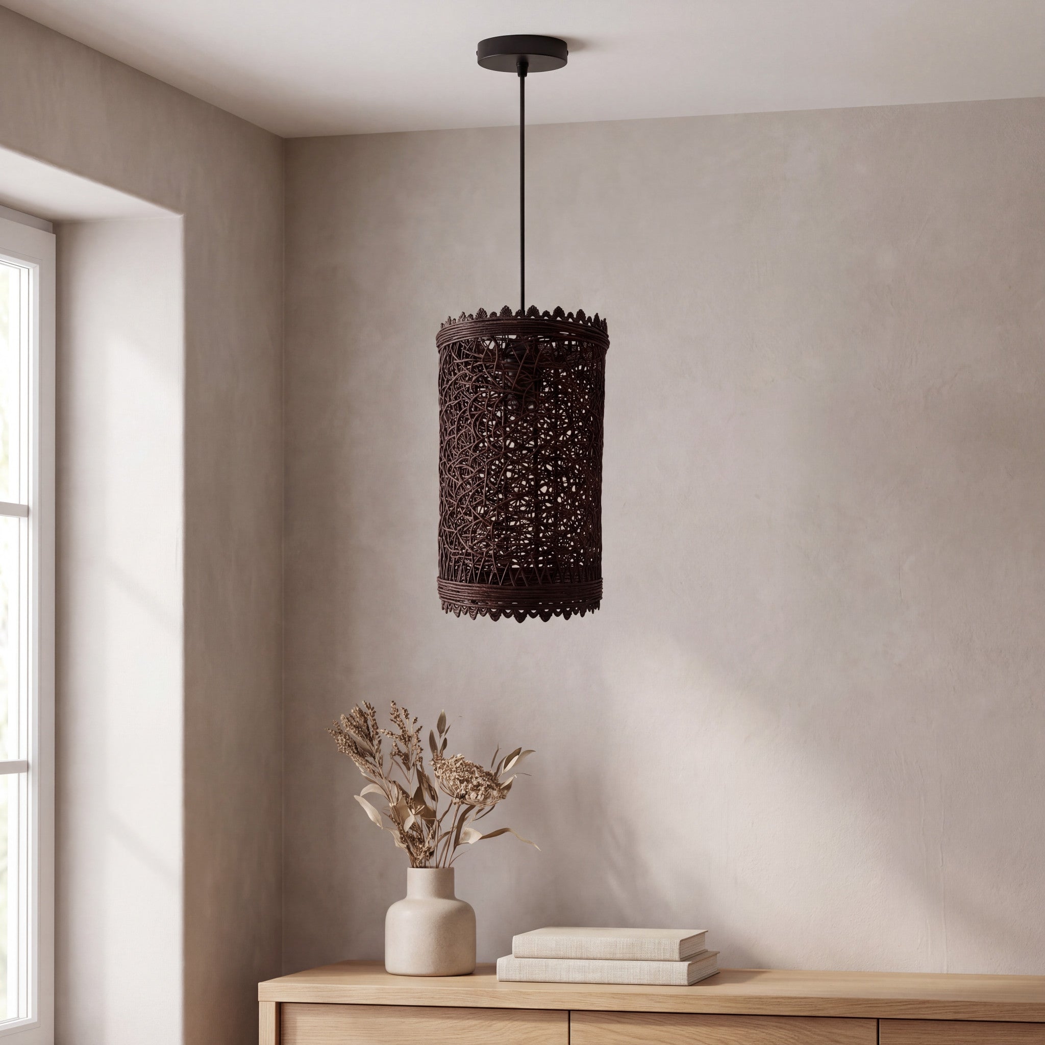 Natural woven rattan pendant light styled above a wooden console in a neutral room