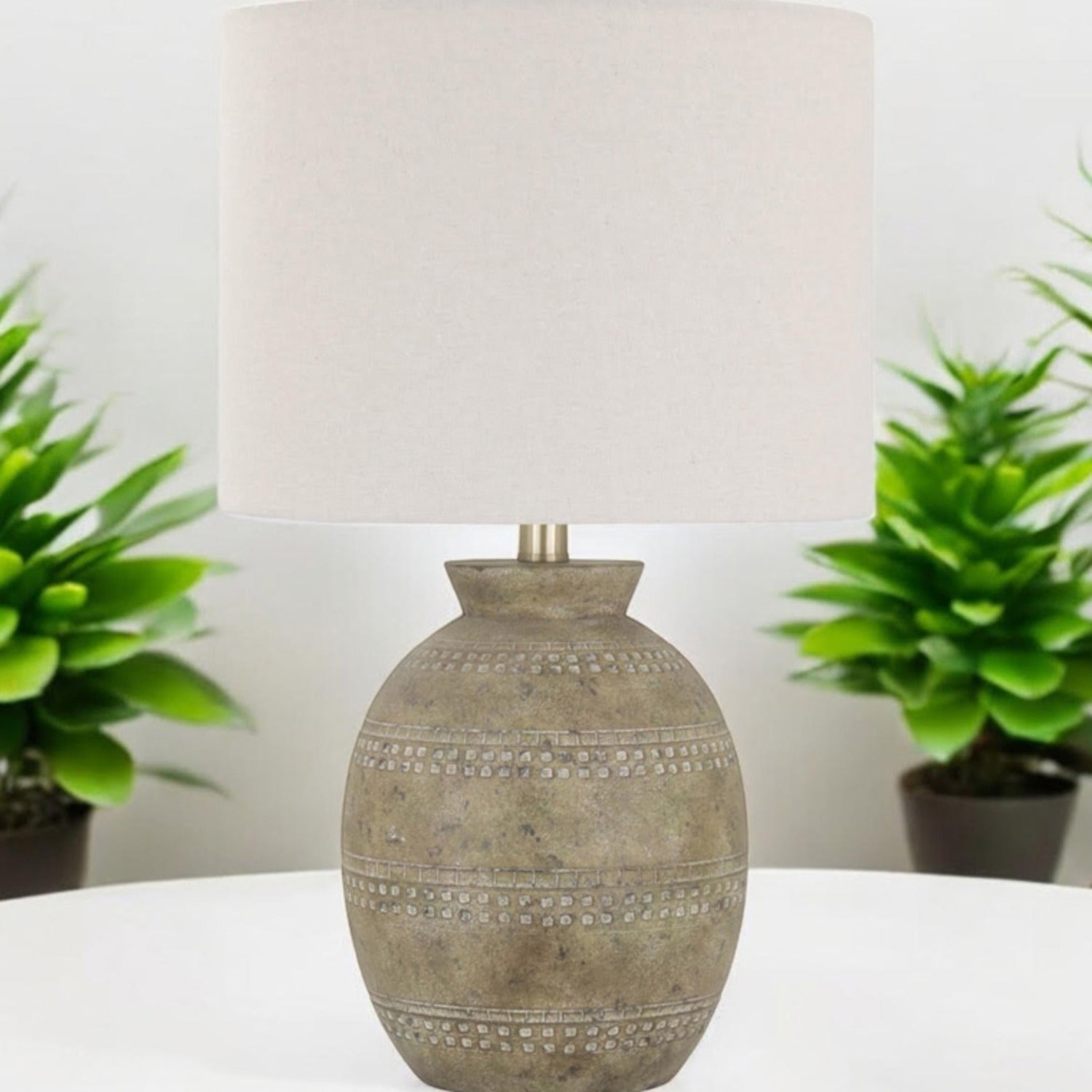 Rustic beige ceramic table lamp on a console tabletop