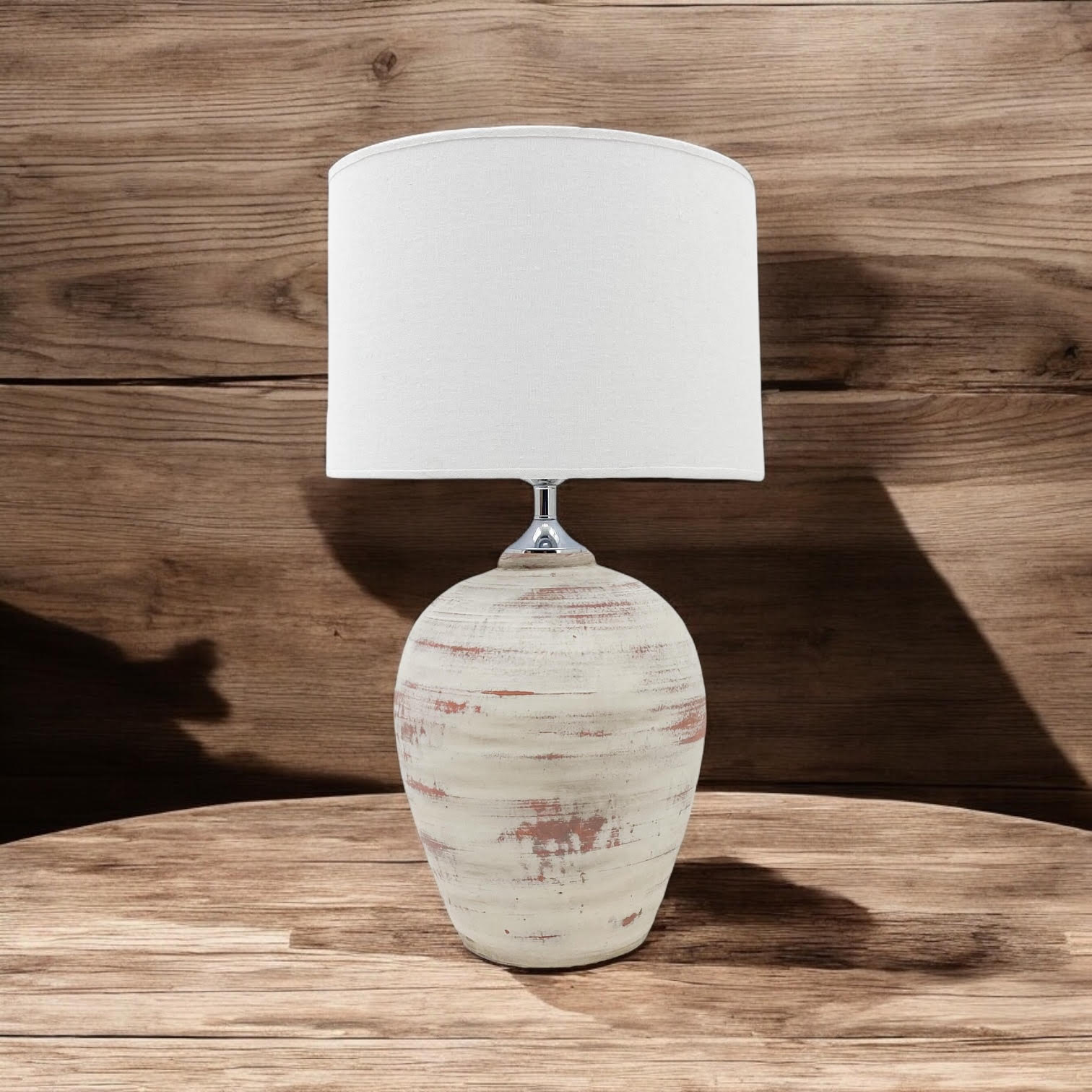 Rustic cream ceramic lamp on a natural wood console