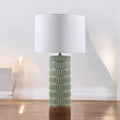 Sage green ceramic table lamp in a minimal neutral interior