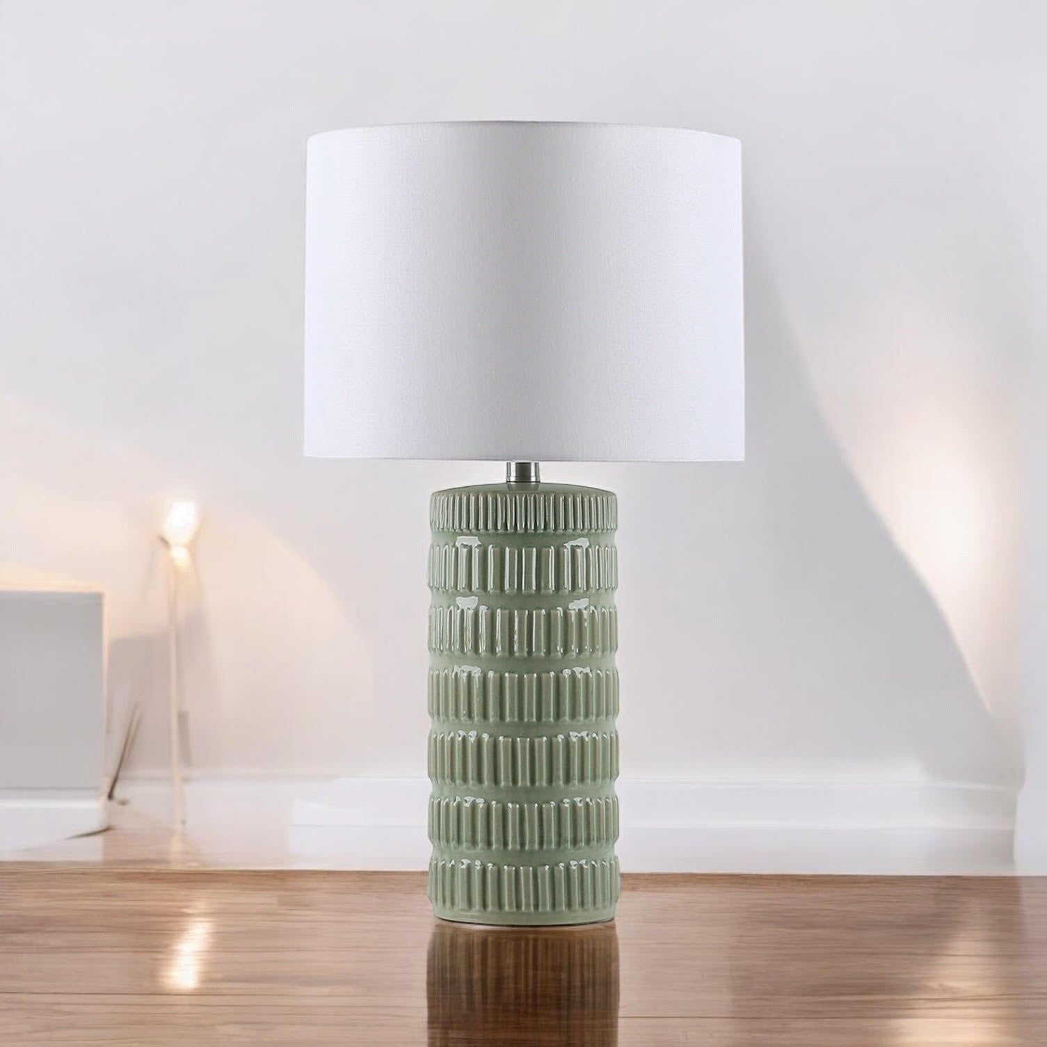 Sage green ceramic table lamp in a minimal neutral interior
