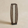 Brown rattan-effect solar floor lamp on a neutral background