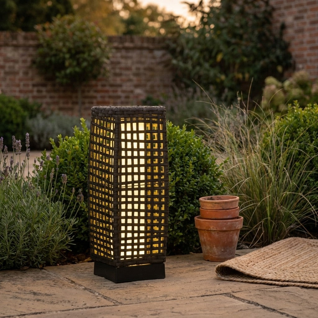 Solar garden lantern with warm light in an evening garden setting