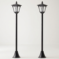 Pair of black solar post lanterns on a white background