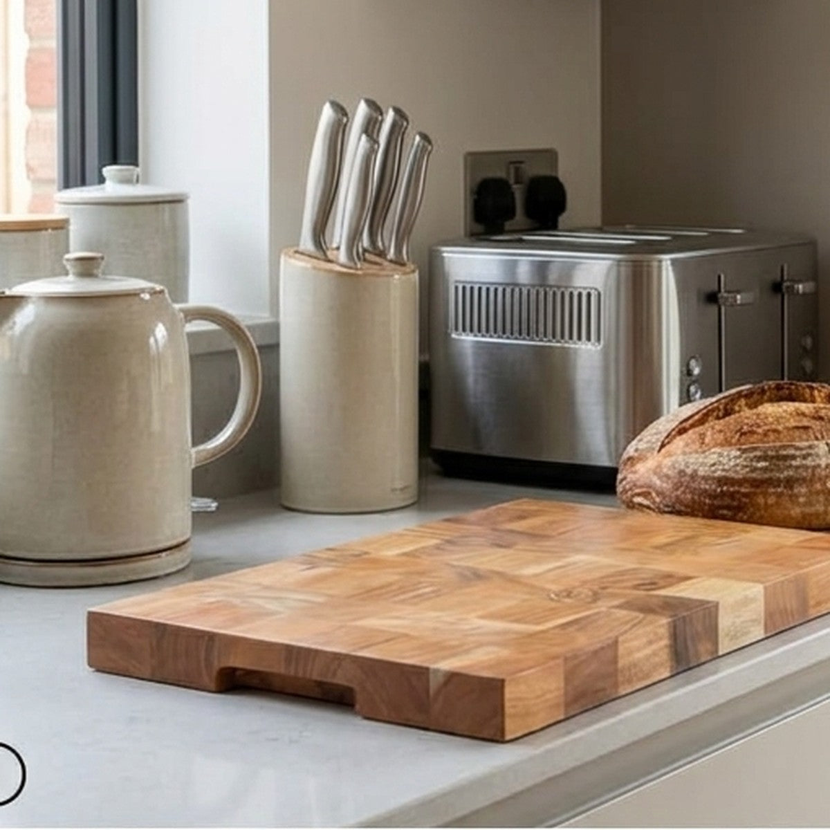 Solid acacia wood chopping board on a modern kitchen worktop