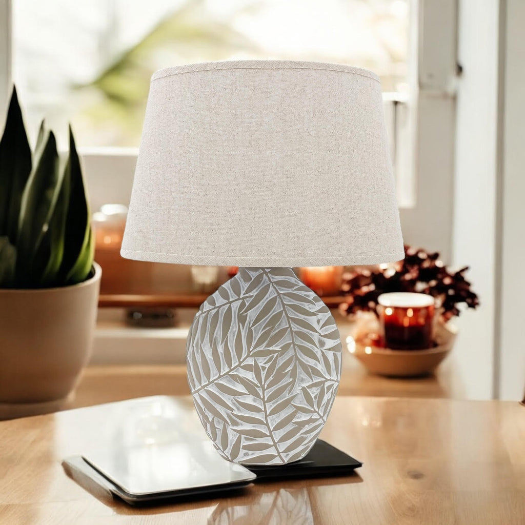 Textured ceramic table lamp with fabric shade on a desk