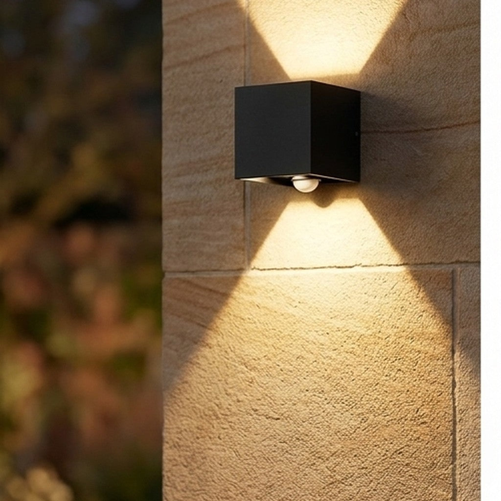 Up and down LED wall light with sensor mounted on a stone exterior wall