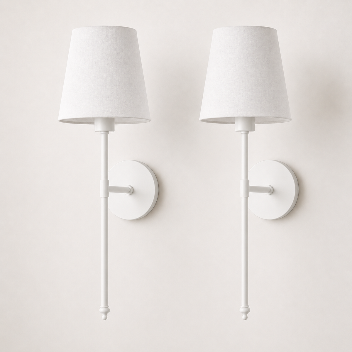 Set of two white wireless wall sconces with white fabric shades